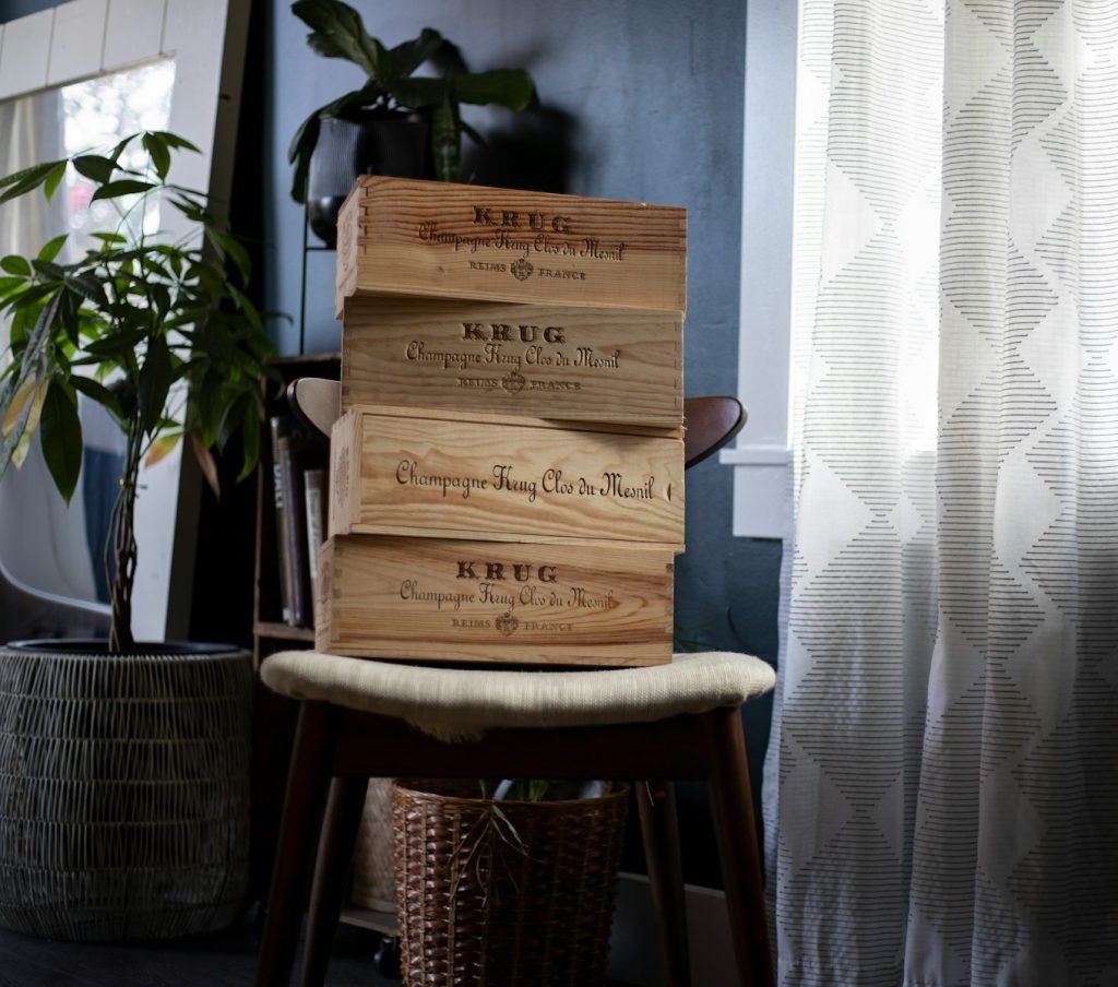 a stack of wooden crates sitting on top of a chair